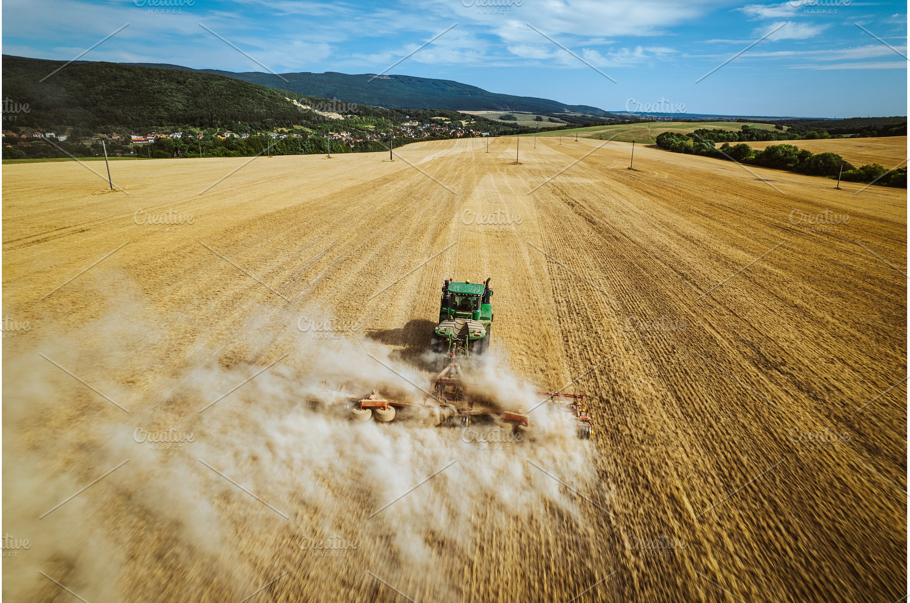 Aerial view of a harvester working, an Industrial Photo by HalfPoint
