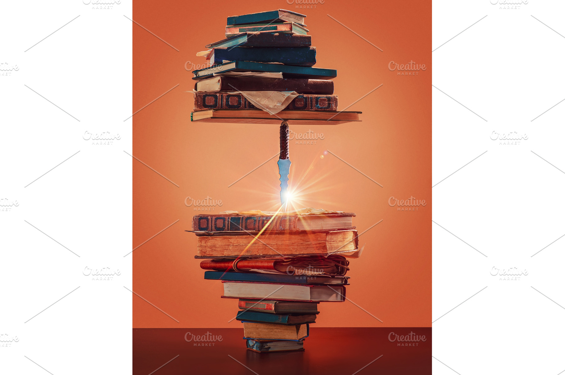 Stack of books with a knife inside, a Technology Photo by dinabelenko