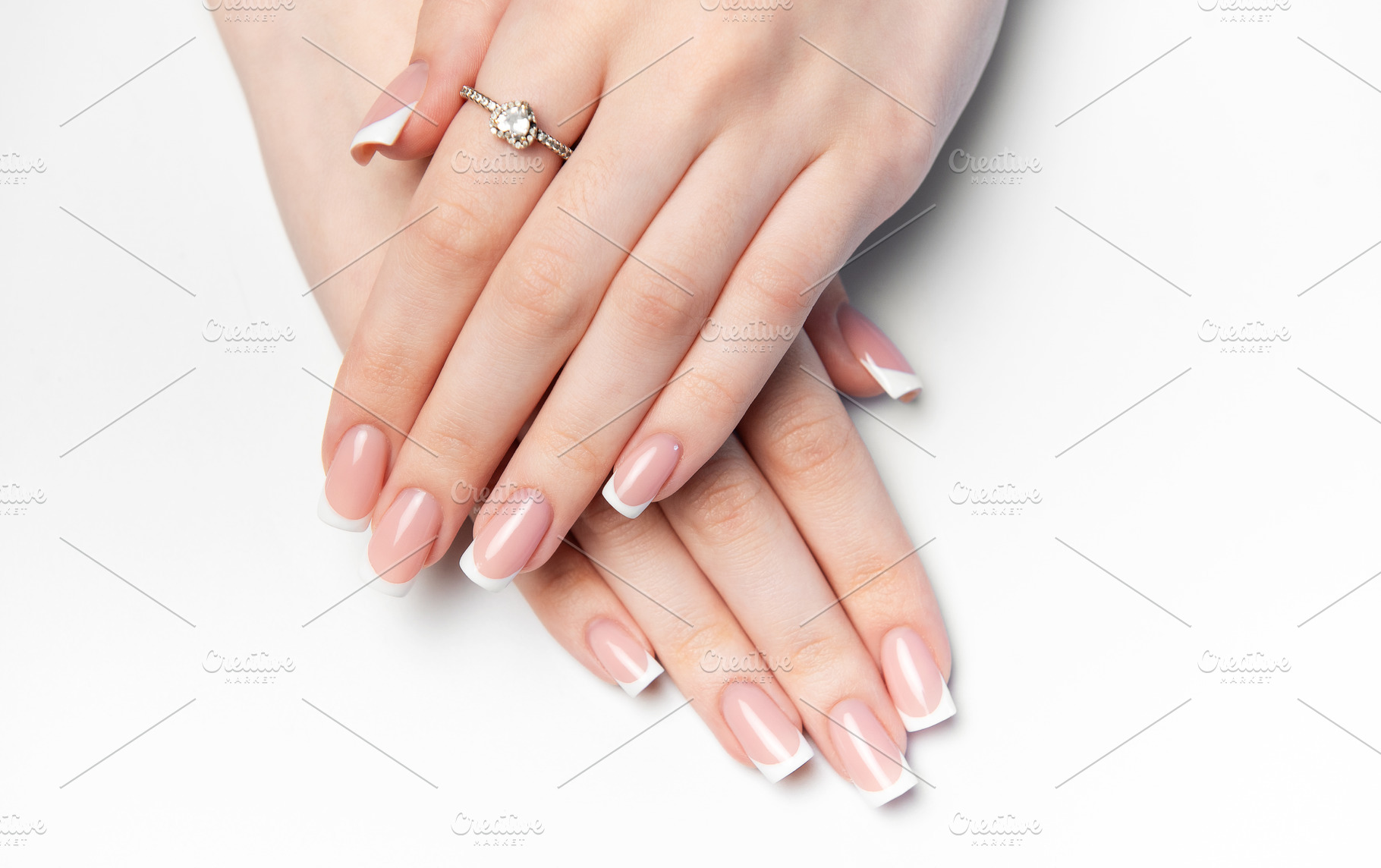 Woman showing french manicure and elegant ring on white backgrou, a Beauty & Fashion Photo by Olena Rudo