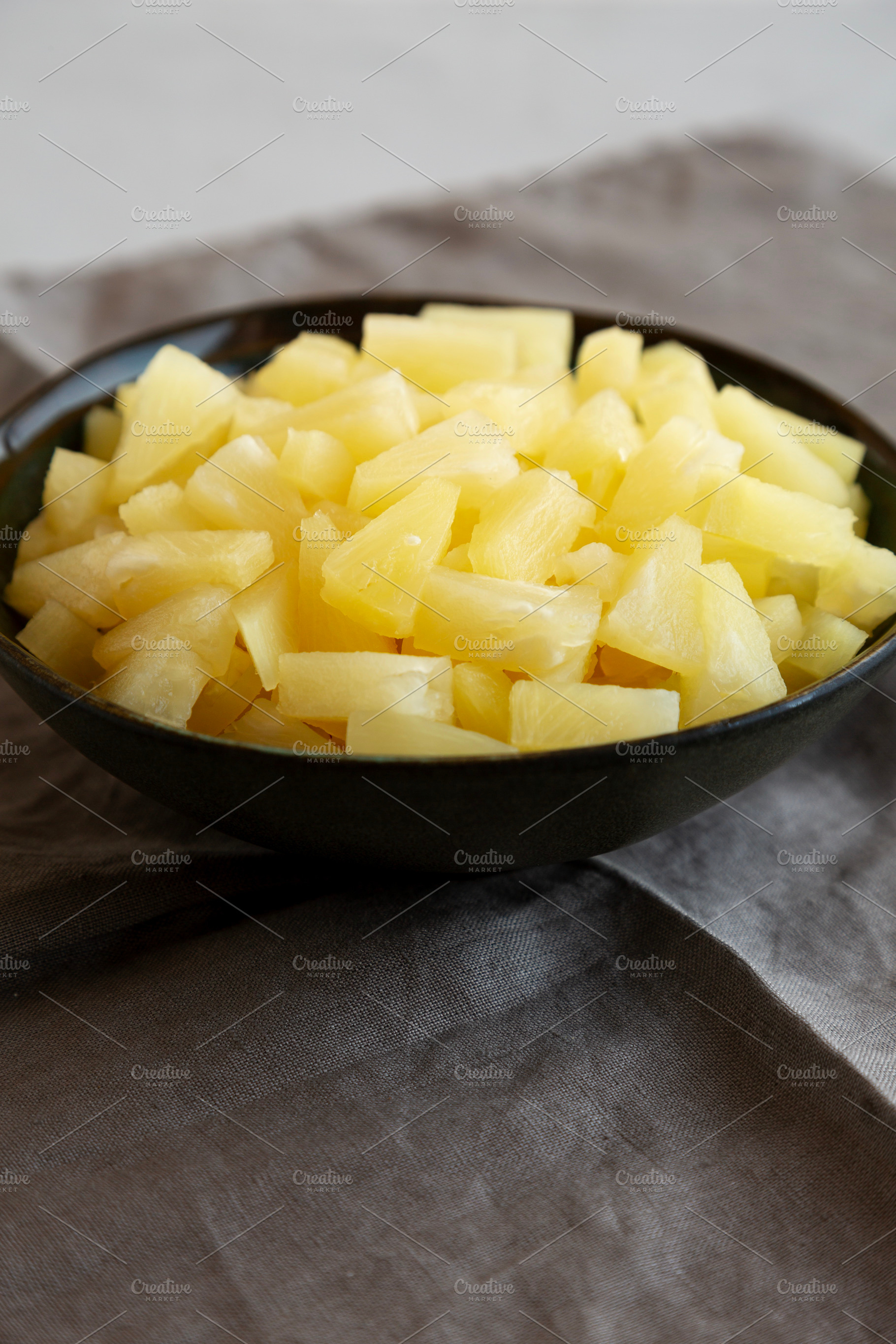 Canned Pineapple Tidbit Chunks in a Bowl, side view., a Food & Drink Photo by LiudmylaChuhunova
