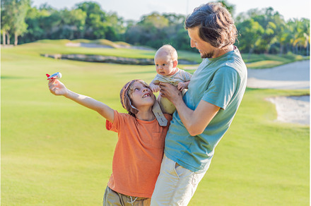 Father with his two sons in the park