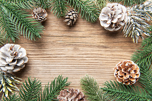 Christmas pine cones and fir branches on wooden background, a Holiday Photo by Olena Rudo