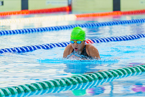 Swimmer child swims breaststroke swimming style in a race swimmi