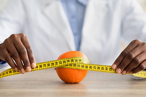 Cellulite is consequence of poor nutrition. African american nutritionist holdi, a Person Photo by Prostock-Studio