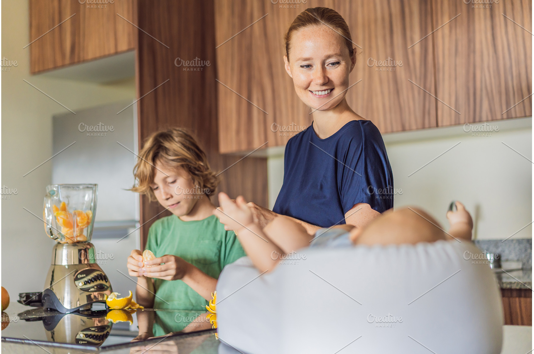 Mother and son preparing smoothie in, a Person Photo by Elizaveta Galitskaya