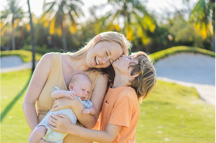 Mother, older son, and newborn baby