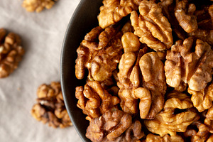 Raw Walnut Halfs in a Bowl, top view. Flat lay, overhead. Close-, a Food & Drink Photo by LiudmylaChuhunova