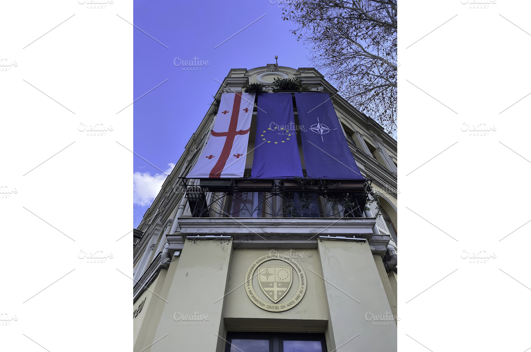 Flags displayed on a historic, an Architecture Photo by Media Whale Stock