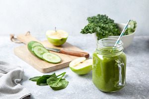 Kale smoothie in a glass jar containing kale, green, and drink