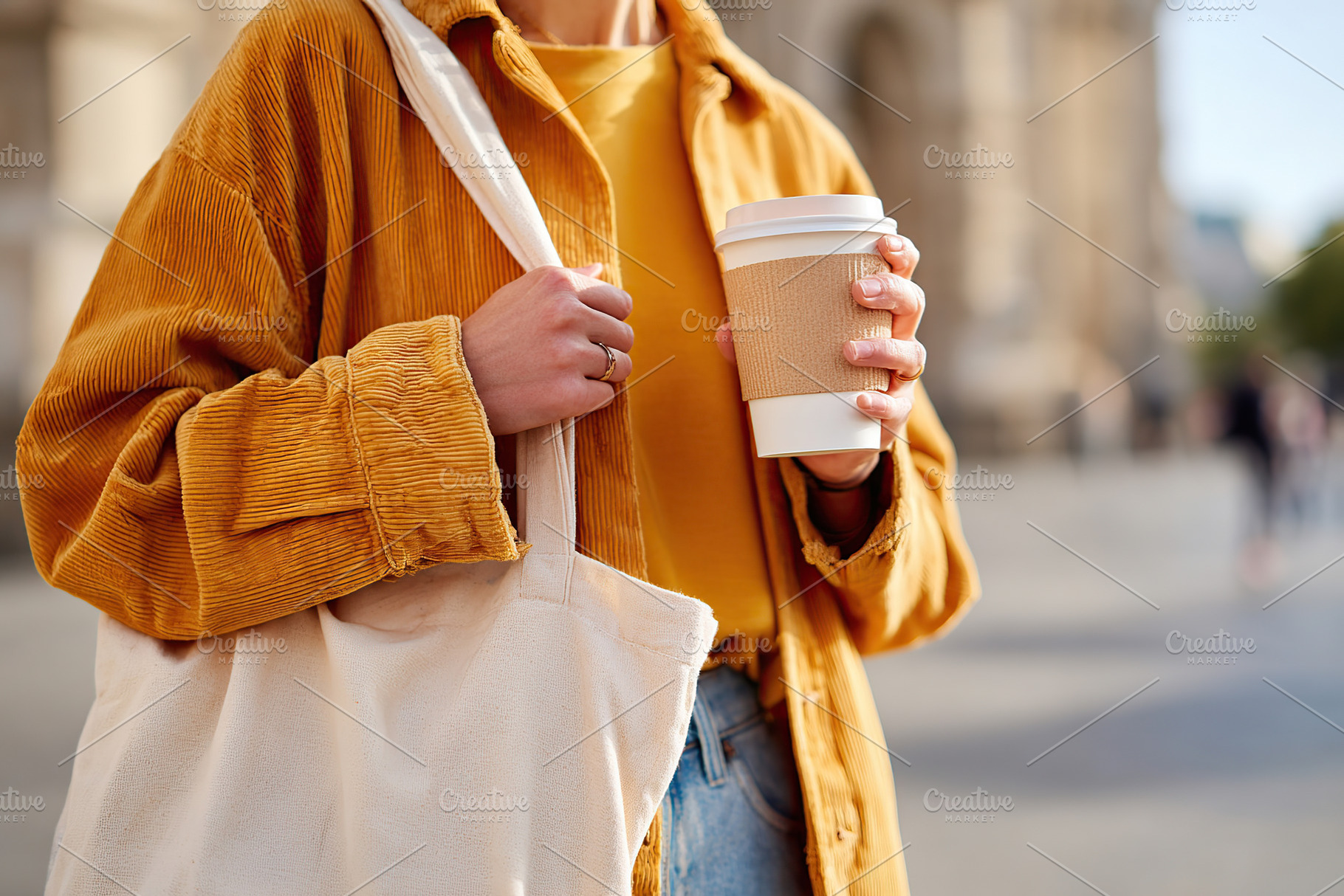 Holding a reusable coffee cup and cloth bag while exploring a city street in th, a Food & Drink Photo by AlyaAnd