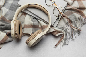 Warm plaid, headphones, book, and eyeglasses creating cozy atmos, a Technology Photo by Olena Rudo