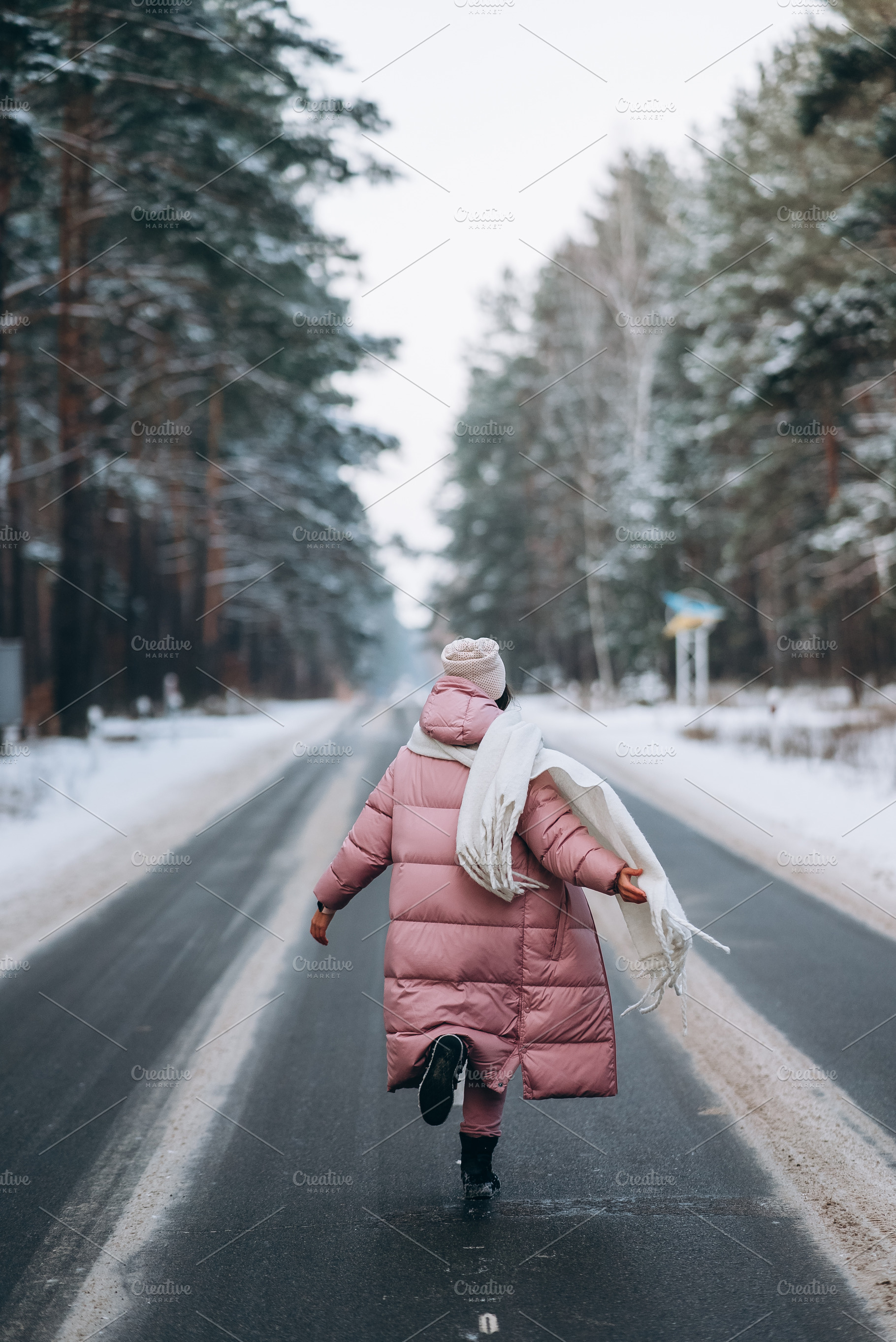 Portrait of a beautiful caucasian woman on a road through snowy forest, a Person Photo by Tekso