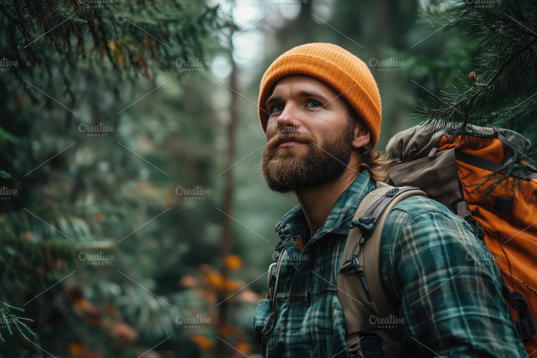 A forester man with a beard and orange beanie stands in a lush green forest, lo, a Person Photo by Textures & Backgrounds