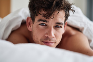 Young man with tousled hair, lying, a Person Photo by MistyDay