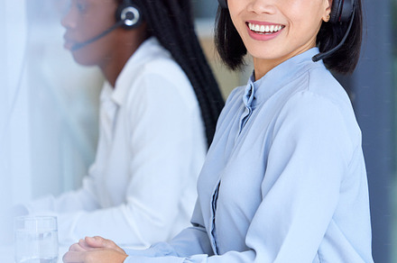 Call center, crm and Asian worker with a smile for telemarketing, online support and customer service. Contact us, corporate and portrait of a Asian consultant working as an agent for a company, a Photo by Peopleimages.com