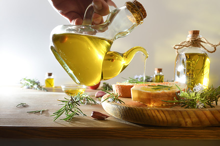 Bottle and bowl with rosemary-essential oil on wooden bench, a Food & Drink Photo by Davizro's Market
