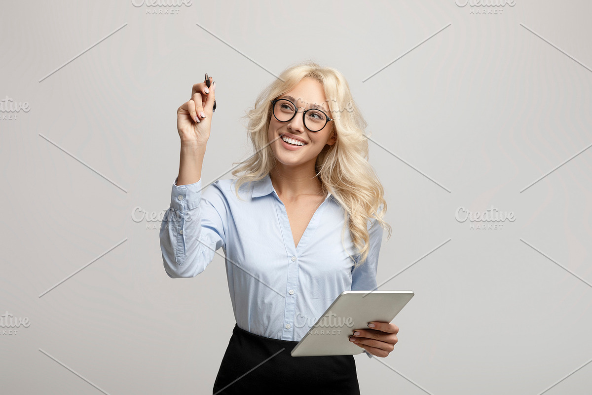 Smart young businesswoman with marker writing or drawing on virtual screen, sta, a Photo by Prostock-Studio (Photo 3 of 3)