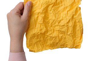 A woman's hand holds a vertical sheet of crumpled yellow paper,, a Person Photo by ndanko