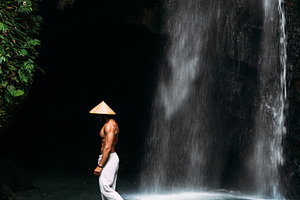 Man at the waterfall containing active, activity, and adventure