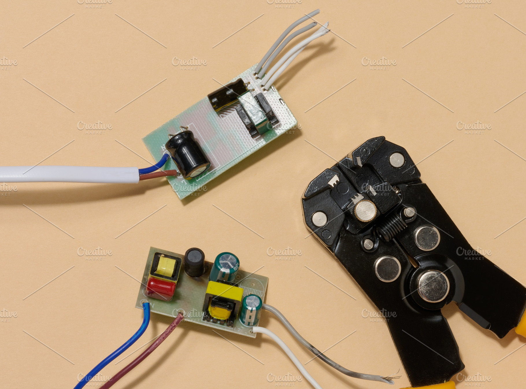 Two green electronic boards with components and wire stripper on, a Technology Photo by ndanko