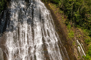 Tall waterfall cascading down rocky, a Nature Photo by Elena Vagengeim
