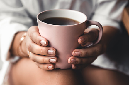 Woman holds morning coffee containing woman, business, and design