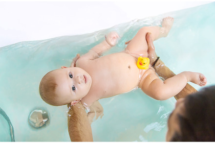The father bathes the little baby, a Person Photo by yanadjana