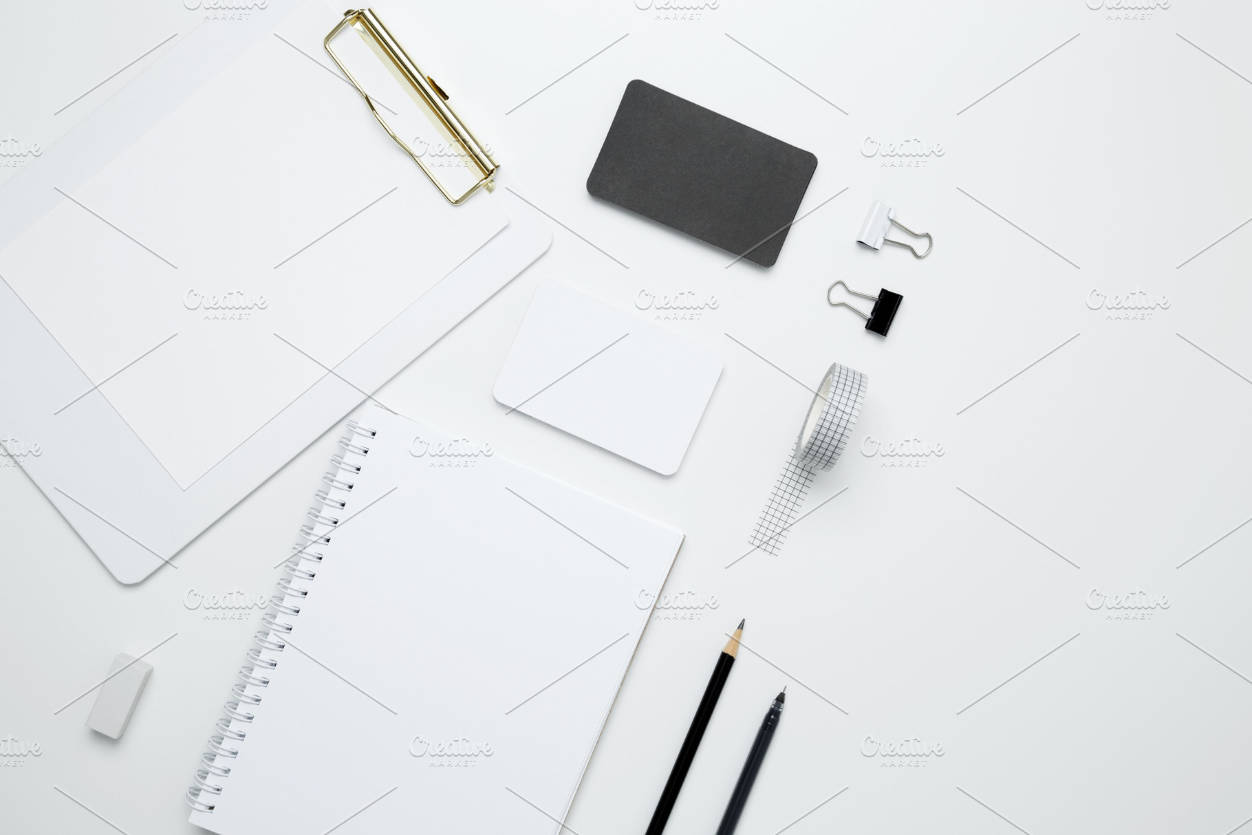 Monochrome stationery items. On a white background, an empty mock up notebook a, a Photo by matucha