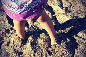 Kid feet in sand