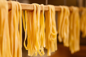 Fresh tagliatelle pasta hanging to d, a Food & Drink Photo by Photostock