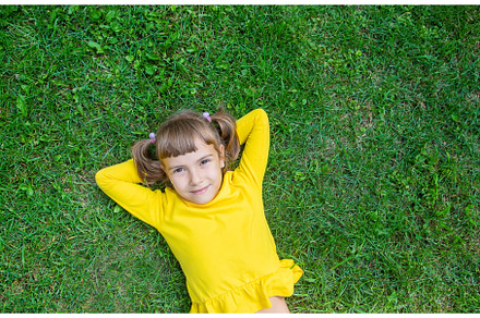 The child lies on the grass, a Person Photo by yanadjana