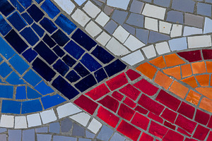 Close-up of a vibrant mosaic featuring curved bands of red, blue, a Background Photo by Ales Munt