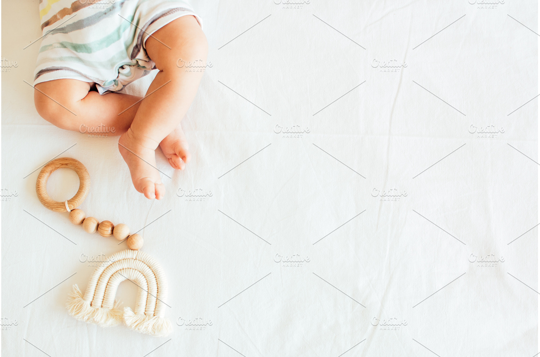 Baby playing with a wooden toy on, a Food & Drink Photo by NelliKovalchuk
