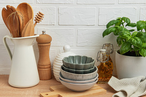 Kitchen utensils, bowls and spices resting on wooden countertop, a Food & Drink Photo by Olena Rudo