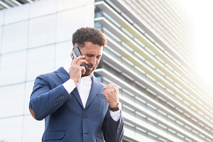 Successful businessman celebrating good news during a phone call, a Business Photo by etorres69