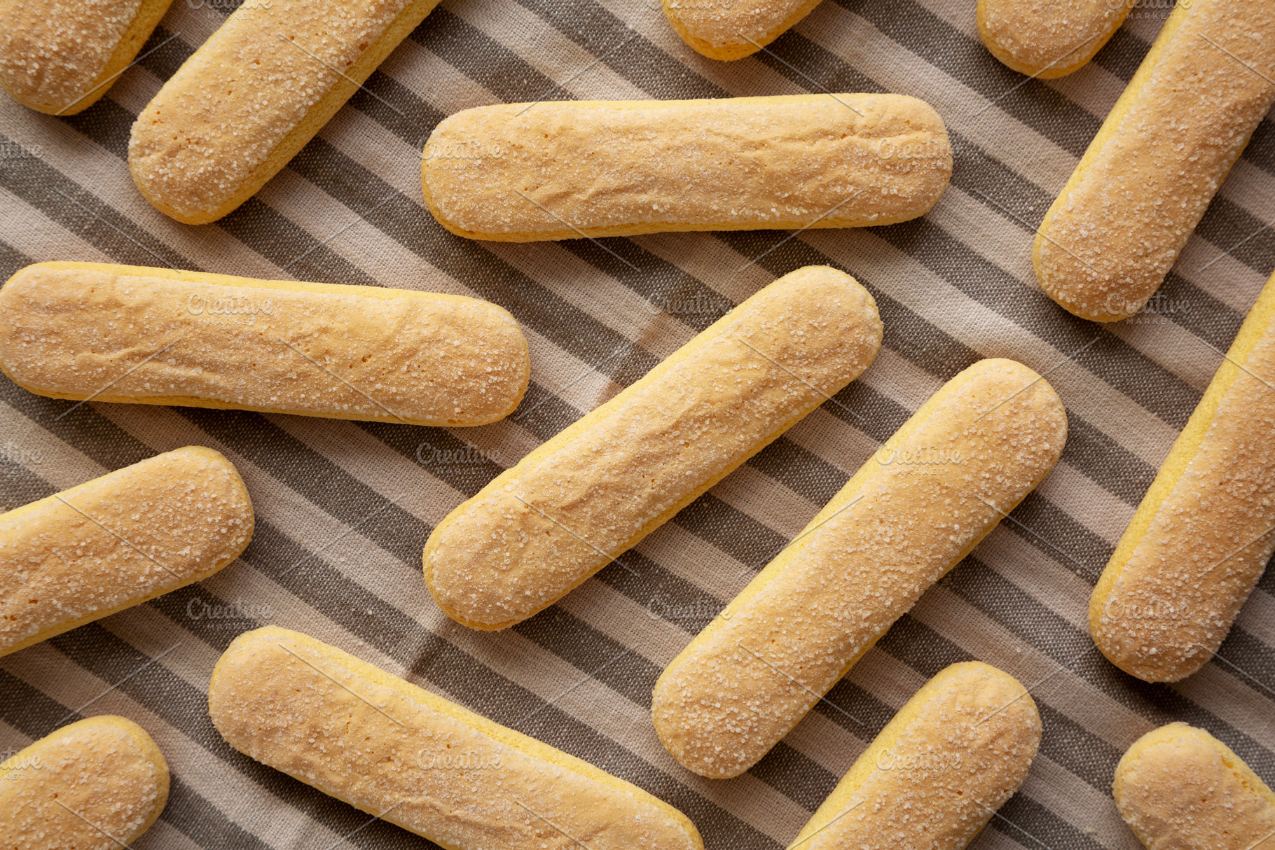 Savoiardi biscuits on a plate, top view. Close-up., a Food & Drink Photo by LiudmylaChuhunova