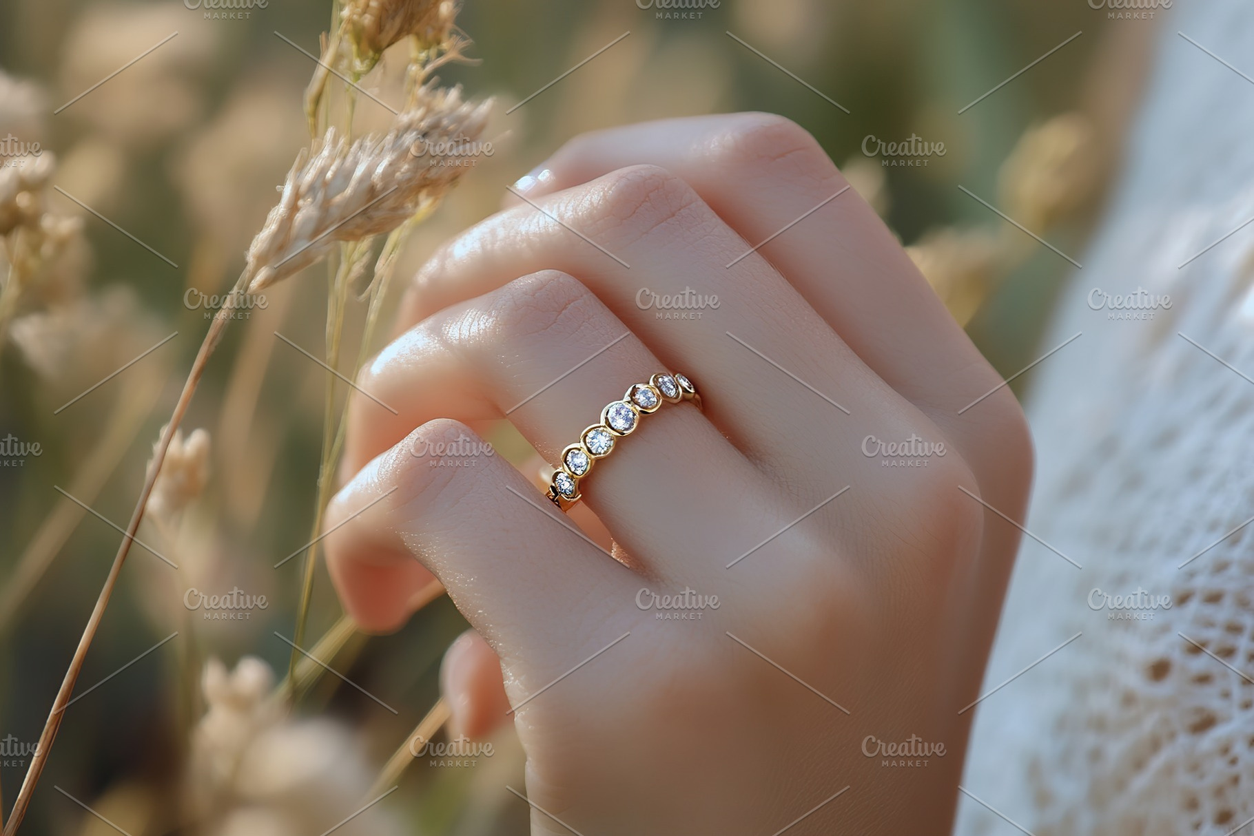 Luxury wedding ring displayed on a finger amidst natural golden grass setting, a Beauty & Fashion Photo by AlyaAnd