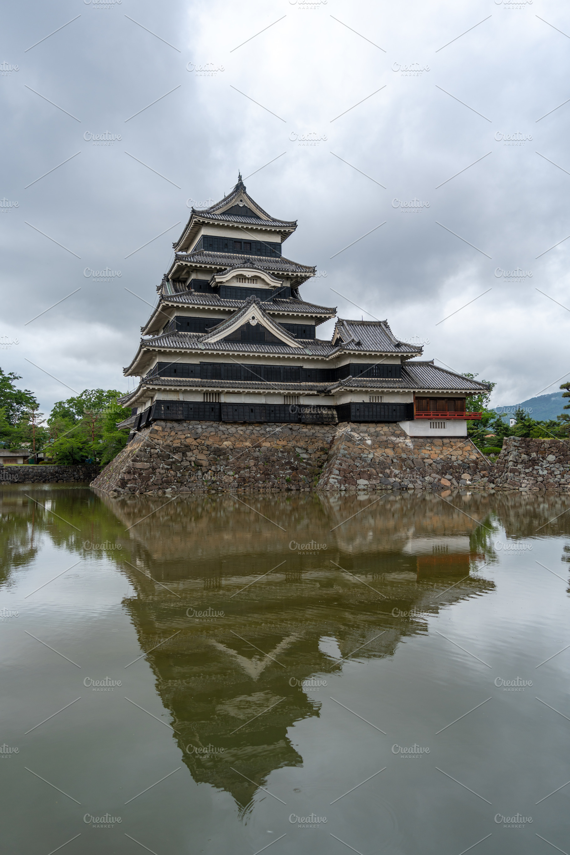 Historic Matsumoto Castle reflected in calm waters, Japan, an Architecture Photo by GoodGoods