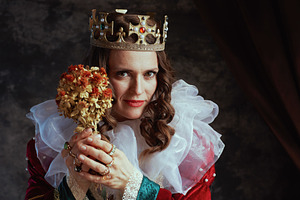 medieval queen in red dress with dried flower and white collar, a Person Photo by Alliance Images