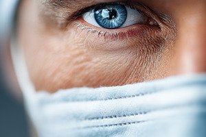 Surgeon’s blue eye behind a surgical, a Health & Medical Photo by MistyDay