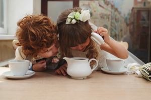 Boy and girl having tea party in featuring tea, party, and kids