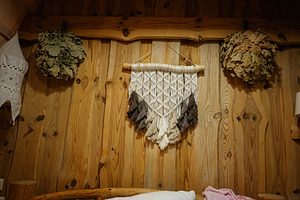 Cozy rustic interior with macrame decor and wooden textured walls, a Photo by AS photostudio