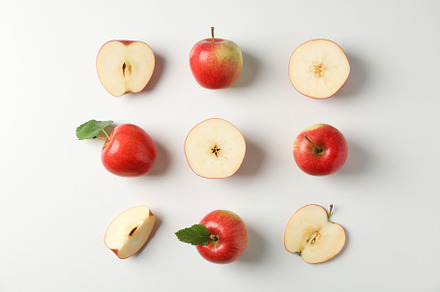 Flat lay with red apples on white background, space for text, a Food & Drink Photo by AtlasStudio