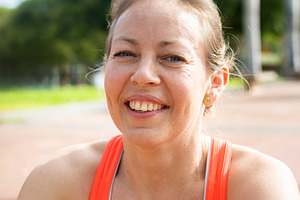 Smiling woman resting after outdoor workout in tropical park, a Sports & Recreation Photo by etorres69