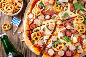 Oktoberfest Pizza with various bavarian sausages, beer and pretz, a Food & Drink Photo by Rimma