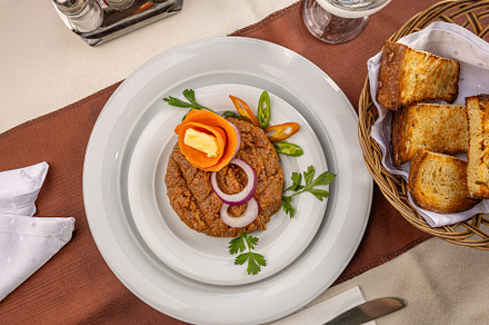 Beef tartare dish with onion rings, a Photo by Grafvision photography