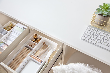 Female white workplace. A method for storing stationery neatly.