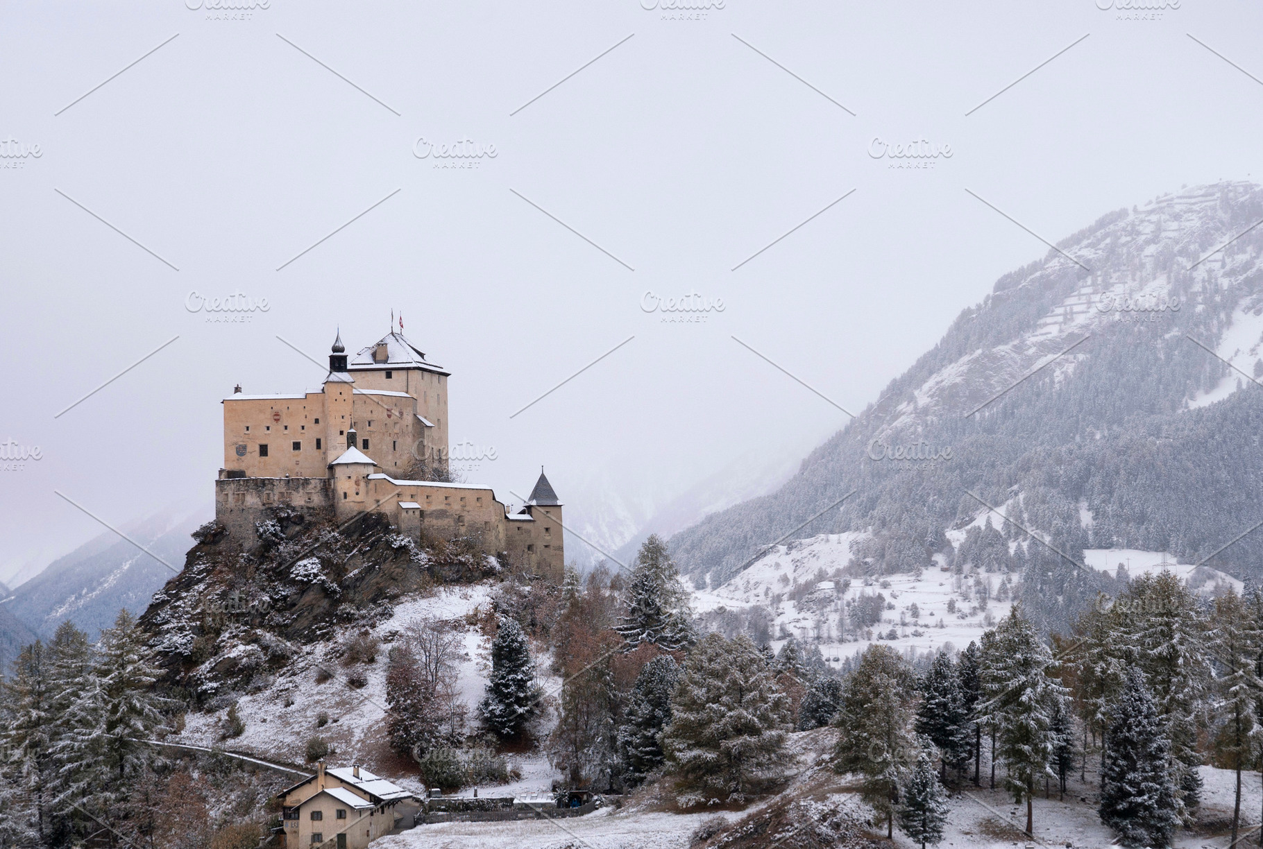 Tarasp castle in a misty and snow covered landscape, a Nature Photo by John Stuij Photography