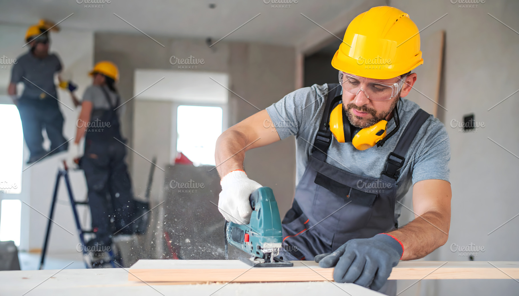Construction Worker Cutting Wood wit, an Industrial Photo by Stock Shape