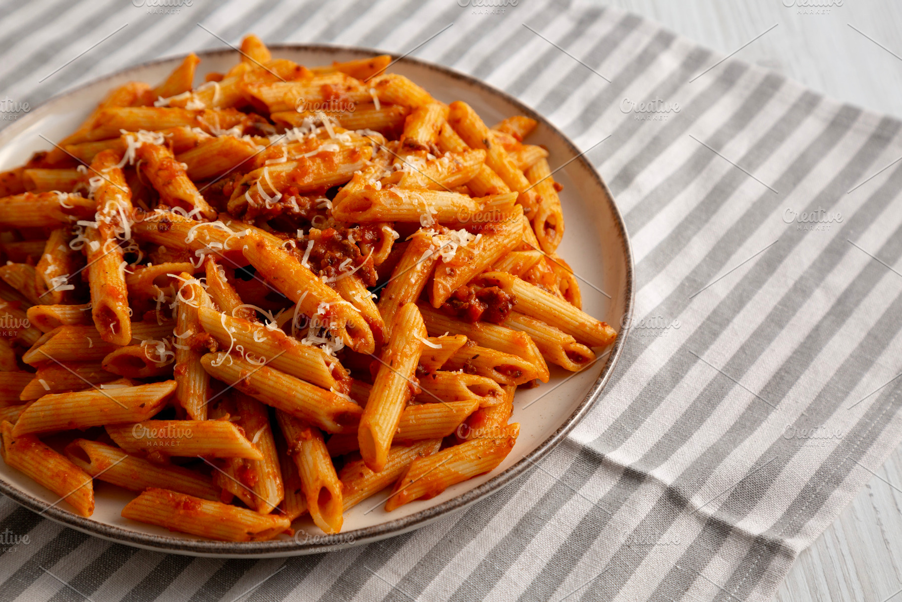 Homemade Pasta Bolognese with Cheese on a Plate, side view. Copy, a Food & Drink Photo by LiudmylaChuhunova